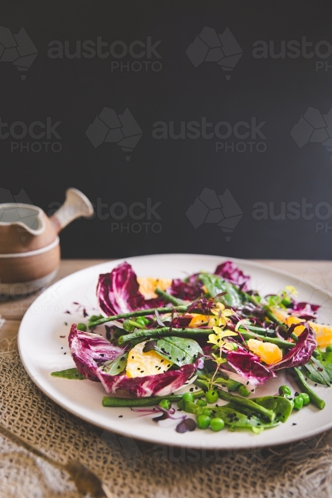 Low angle of a healthy, colourful mixed leaf salad with dark backdrop - Australian Stock Image