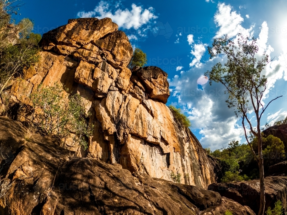 low angle shot of a natural rock formation under a clear blue sky - Australian Stock Image
