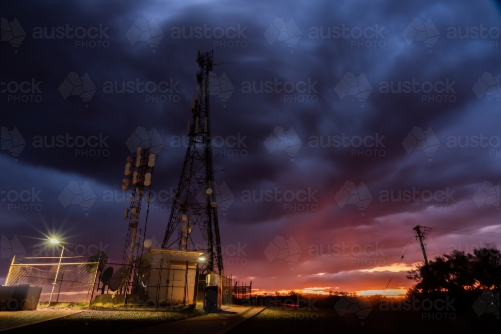 Low angle shot of telecom tower during overcast sunset - Australian Stock Image