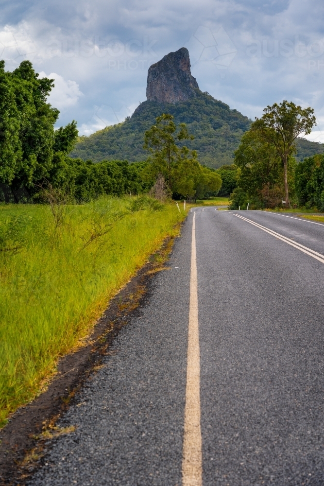 Image of Low angle view of lines on a bitumen road leading off to a ...