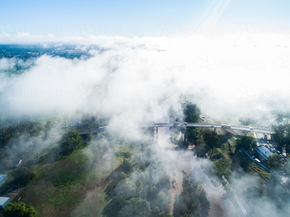 Low cloud and mist covering New England Highway bridge going over the Hunter River in Singleton - Australian Stock Image