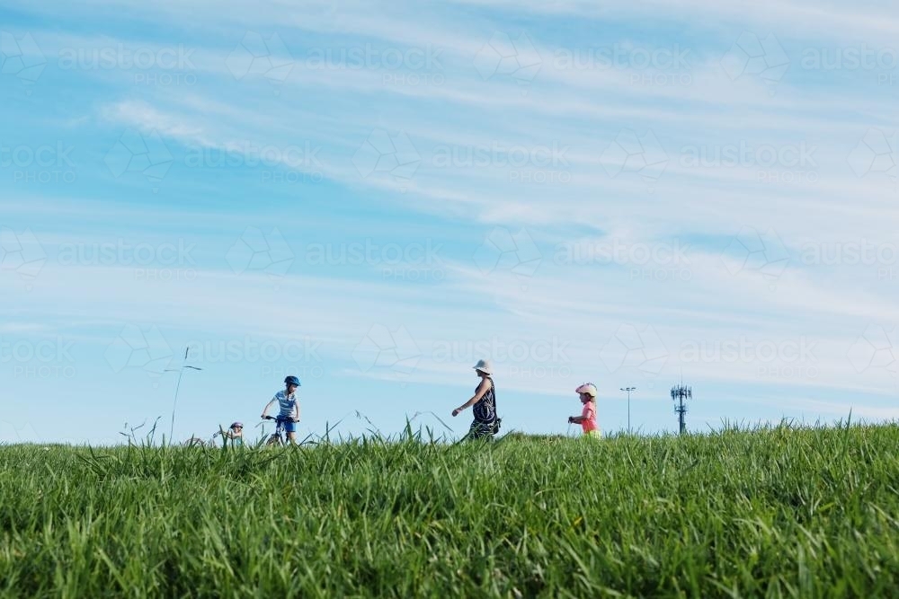 Low view of family out for a walk / ride - Australian Stock Image