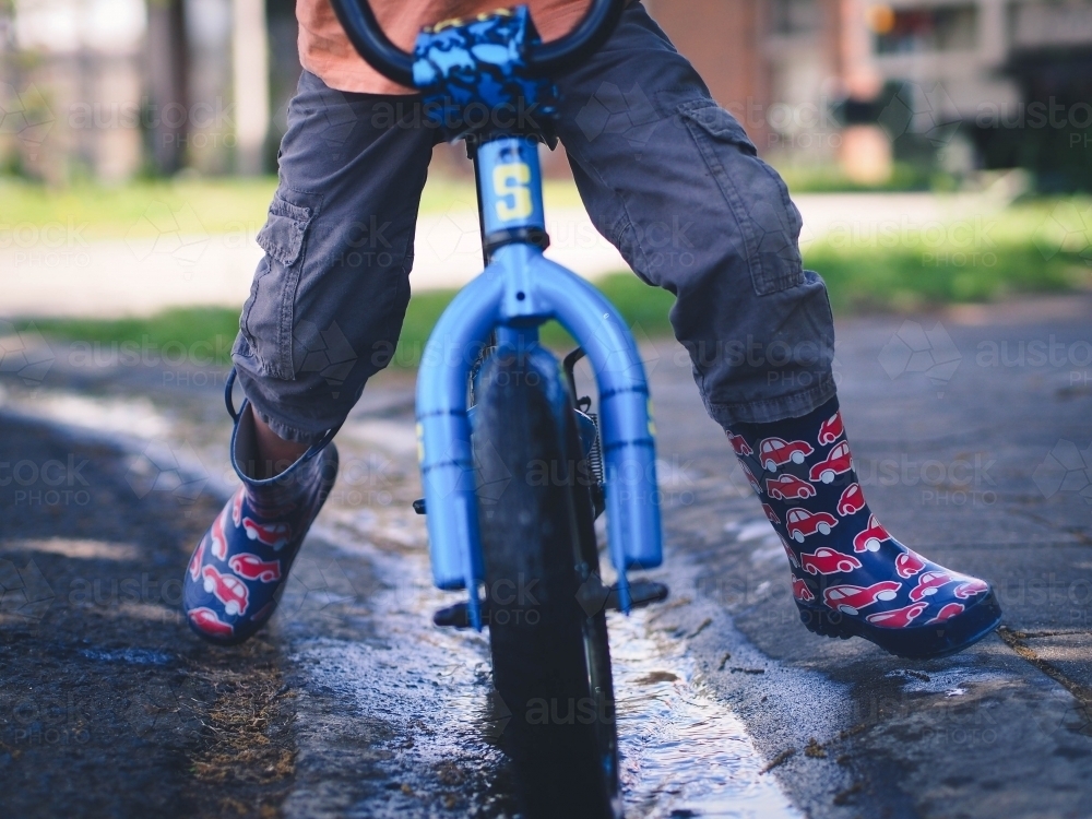 Lower view of child riding a bike - Australian Stock Image