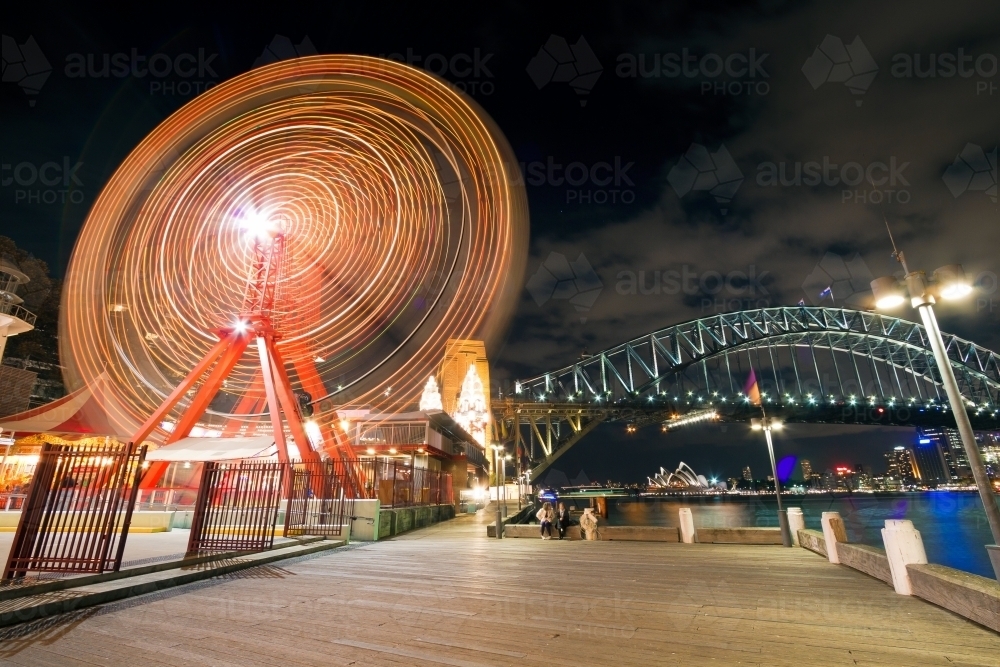 Luna Park ferris wheel and Sydney Harbour Bridge at night - Australian Stock Image