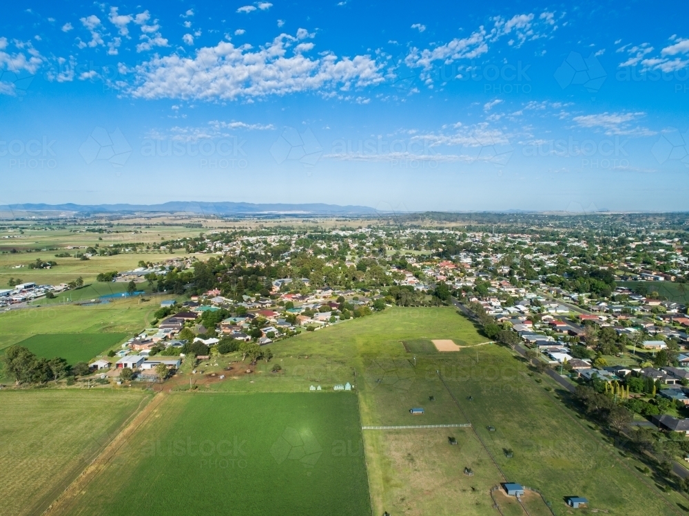 Lush green farm paddocks at the edge of town in NSW Australia - Australian Stock Image