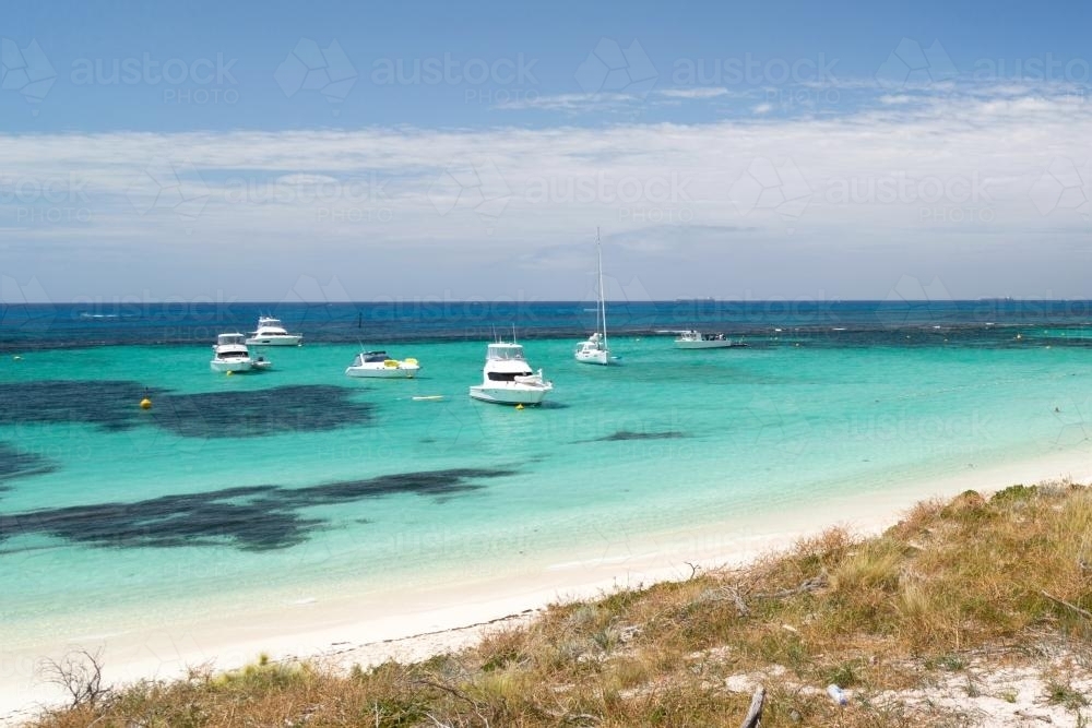 Luxury boats off a turquoise beach - Australian Stock Image