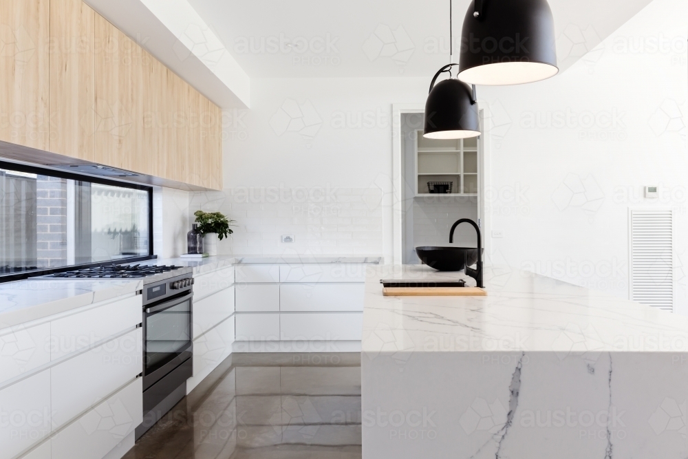 Luxury industrial scandi kitchen with a marble island bench - Australian Stock Image