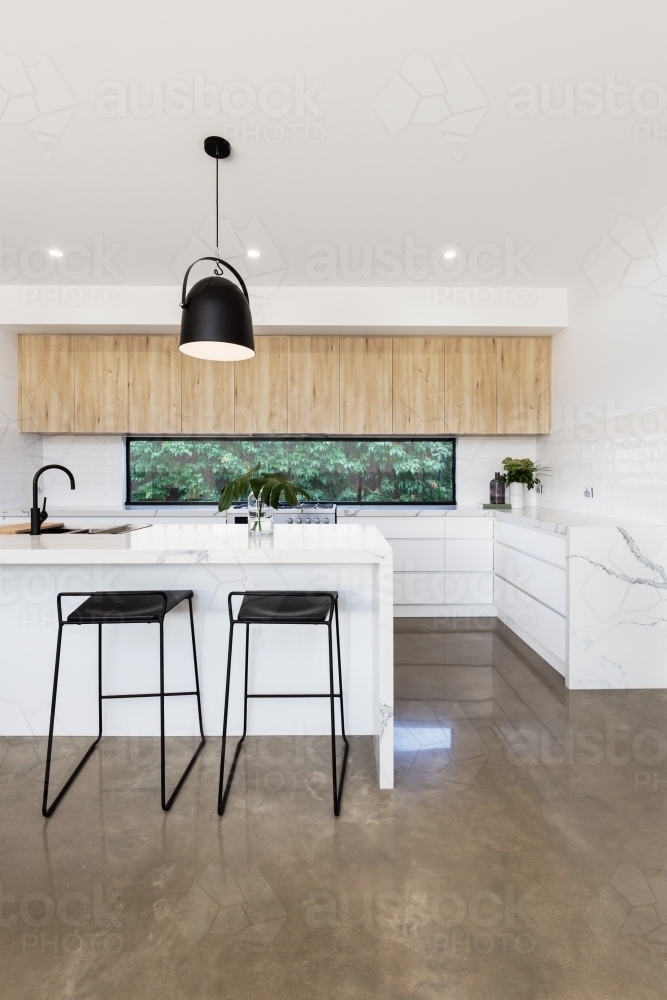 Luxury kitchen with carrara marble waterfall island bench - Australian Stock Image