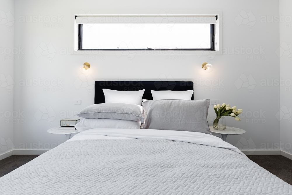 Luxury modern master bedroom with gold wall lights - Australian Stock Image