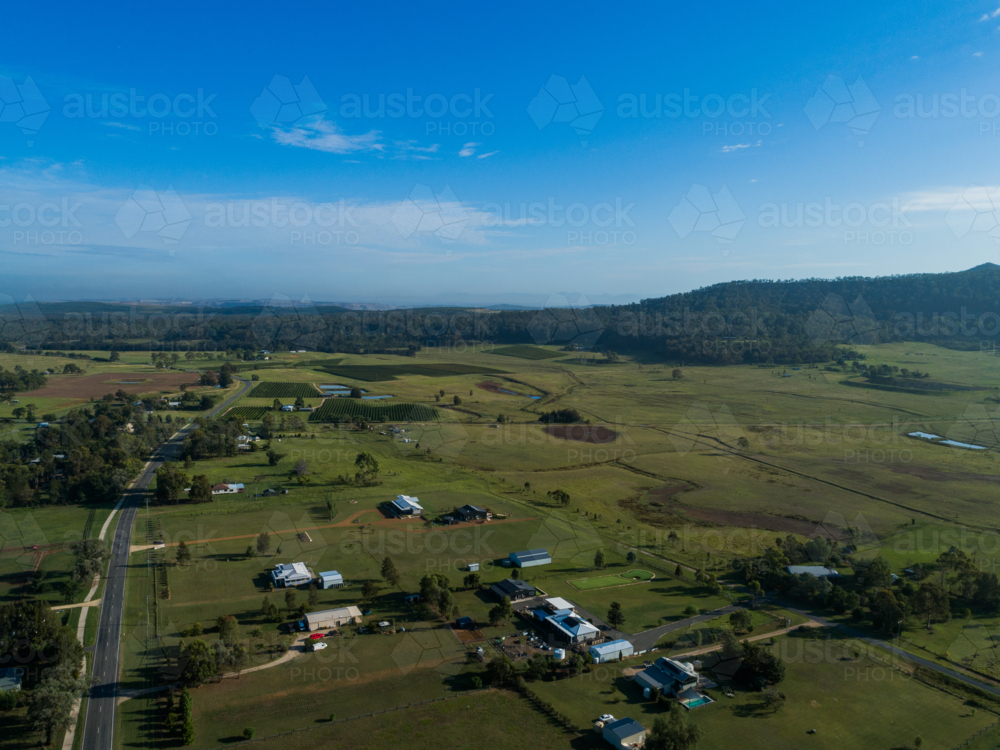 Main road passing through small rural village of Broke in green landscape - Australian Stock Image