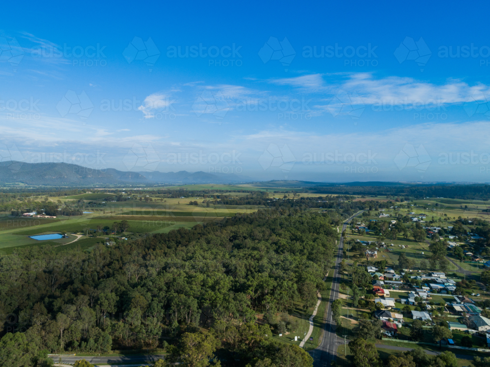 Main road passing through small rural village of Broke in green landscape - Australian Stock Image