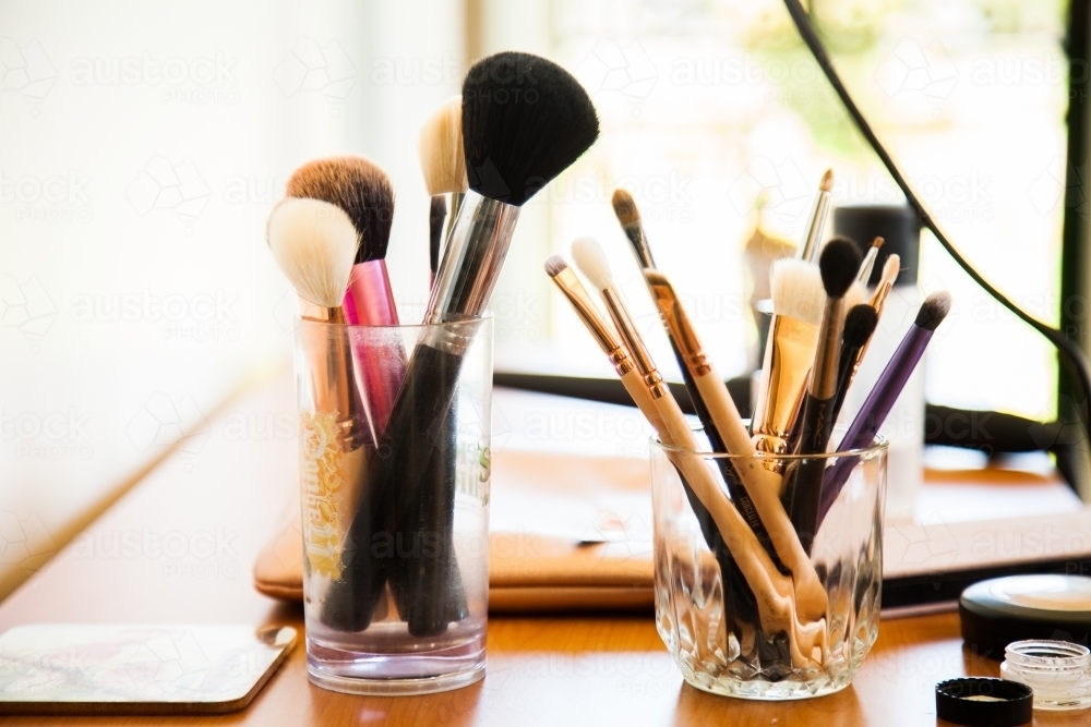 Makeup artist's brushed sitting on table - Australian Stock Image