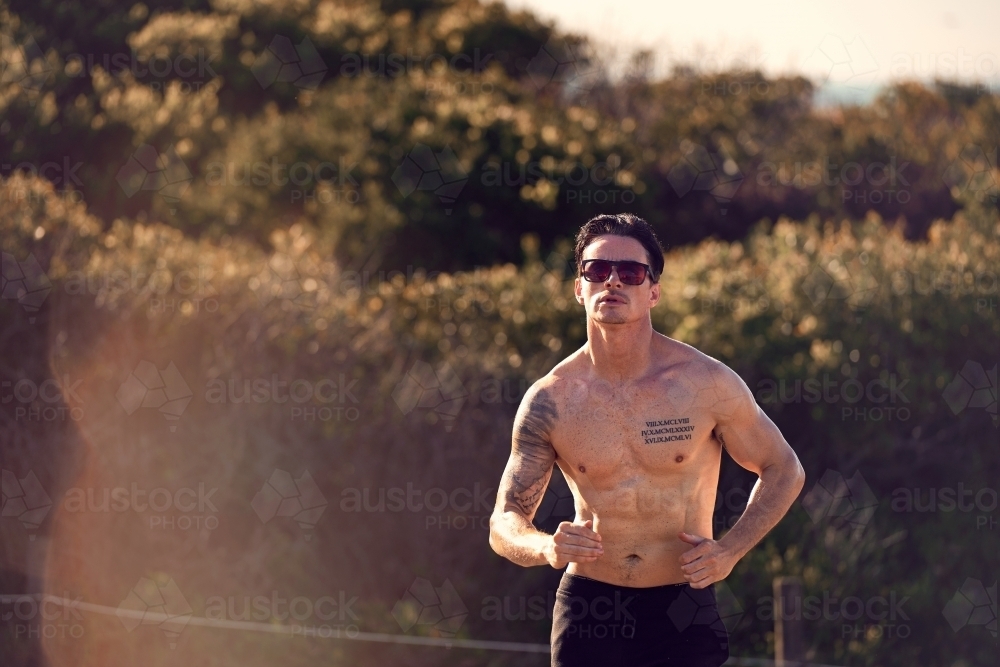 Male exercising on a morning run - Australian Stock Image