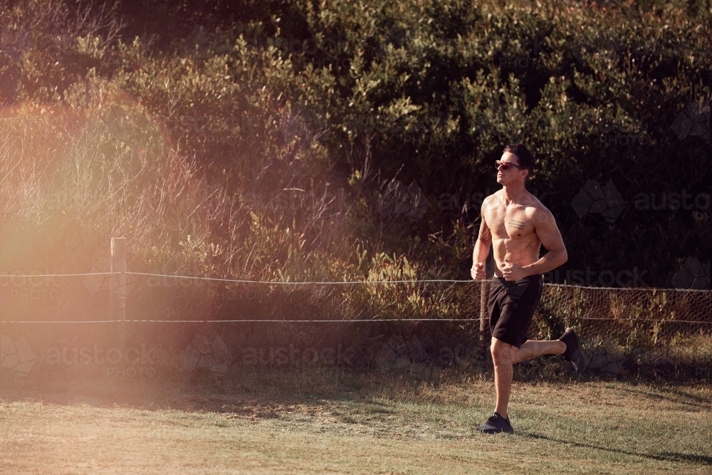 Male exercising on a morning run - Australian Stock Image