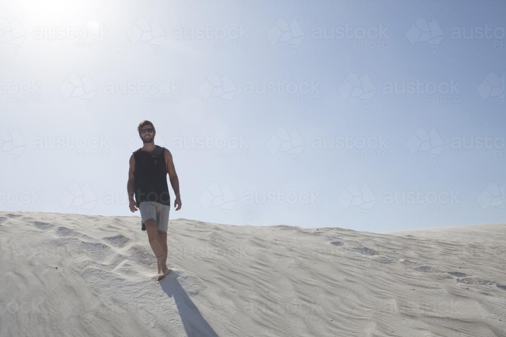 Male exploring the dunes of Perth on a sunny day - Australian Stock Image