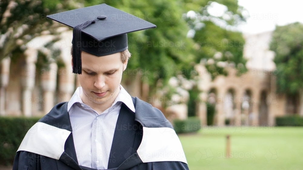 Male graduating university in cape and hat - Australian Stock Image