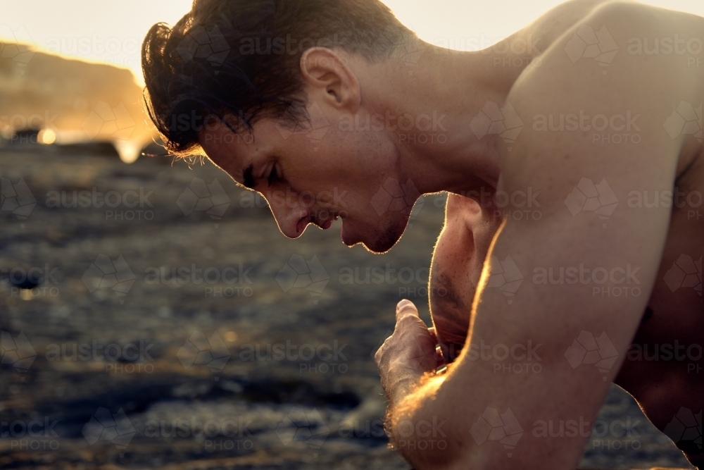 Male person exercising in the morning with workout routine - Australian Stock Image