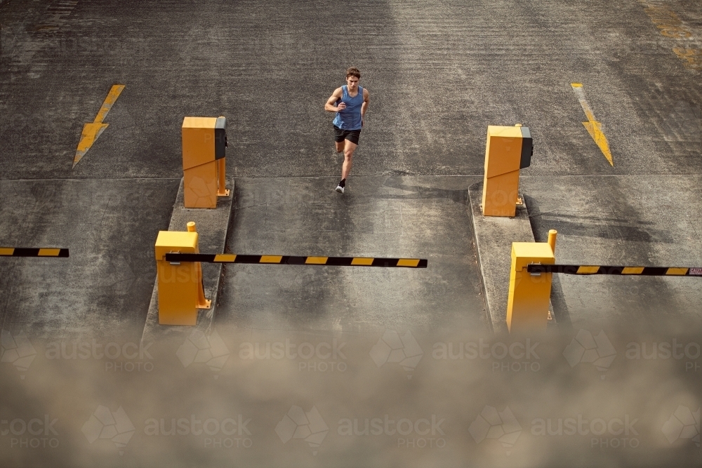 Male runner running through urban setting - Australian Stock Image