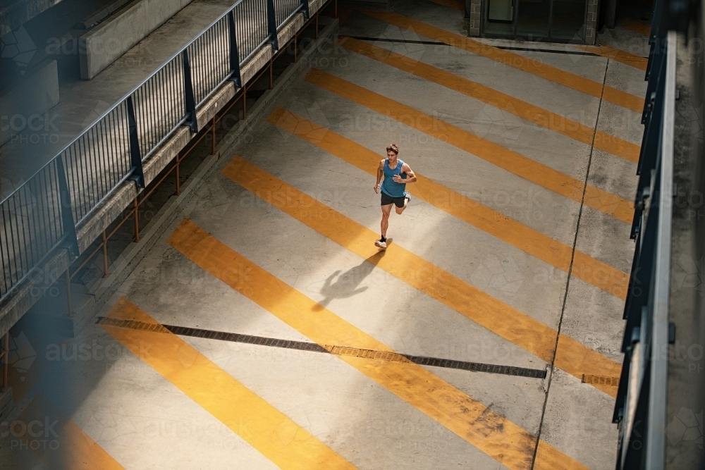 Male runner running through urban setting - Australian Stock Image