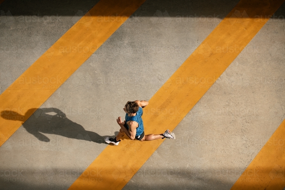 Male runner running through urban setting - Australian Stock Image