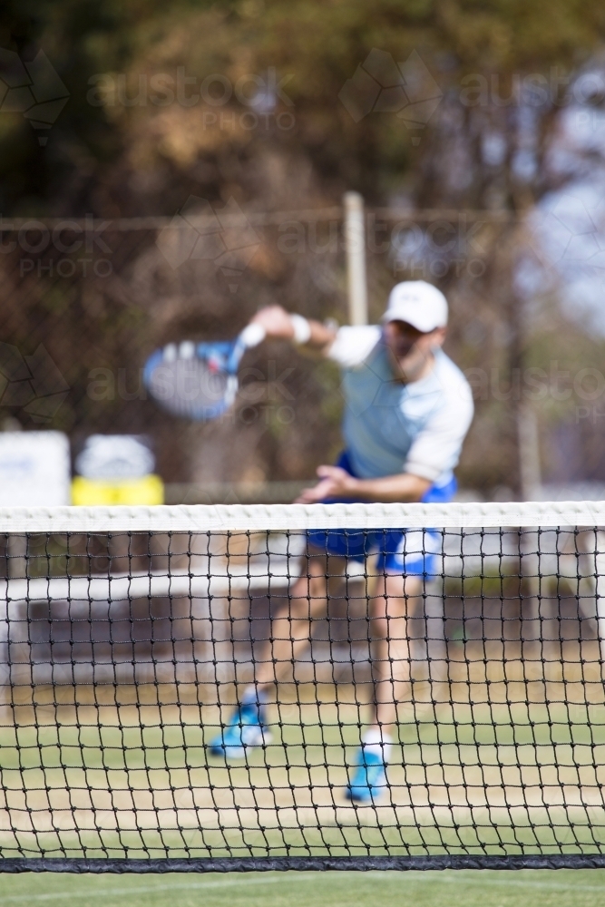 Male tennis player serving the ball - Australian Stock Image