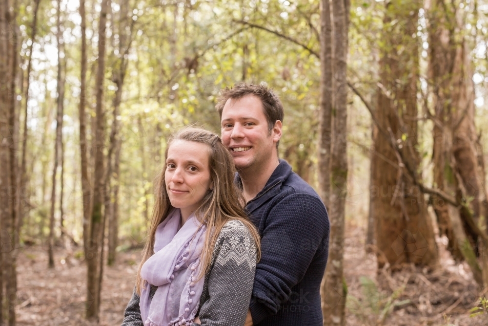 Man and woman in embrace looking at camera - Australian Stock Image