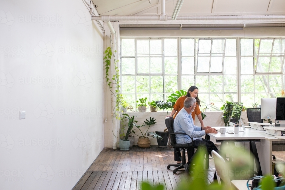 Man and woman meeting in an urban renovated white heritage office space - Australian Stock Image