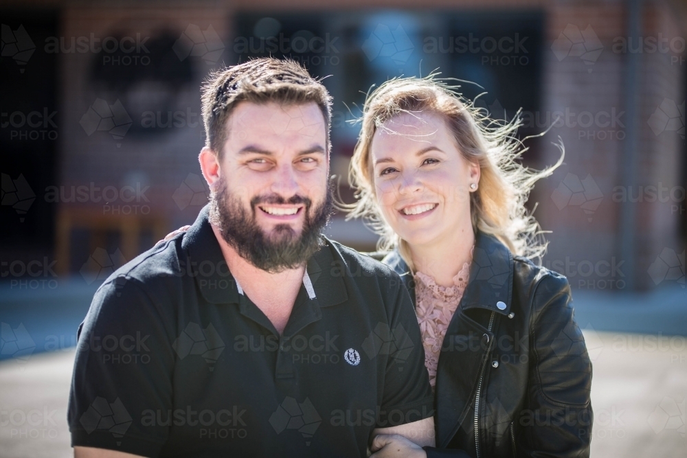 Man and woman outside at home smiling - Australian Stock Image