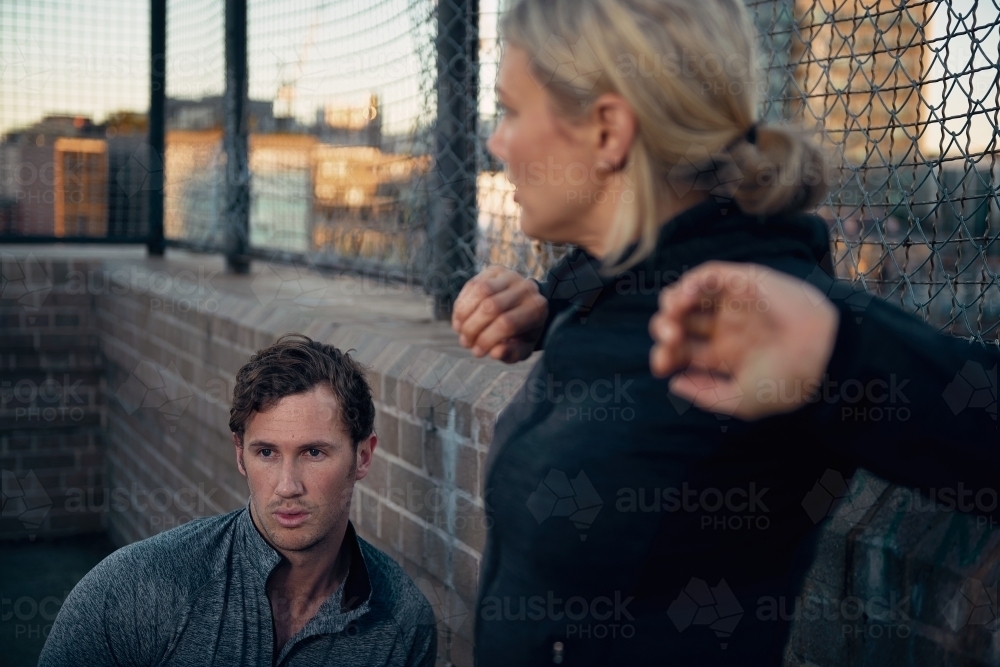 Man and woman resting after game of basketball - Australian Stock Image