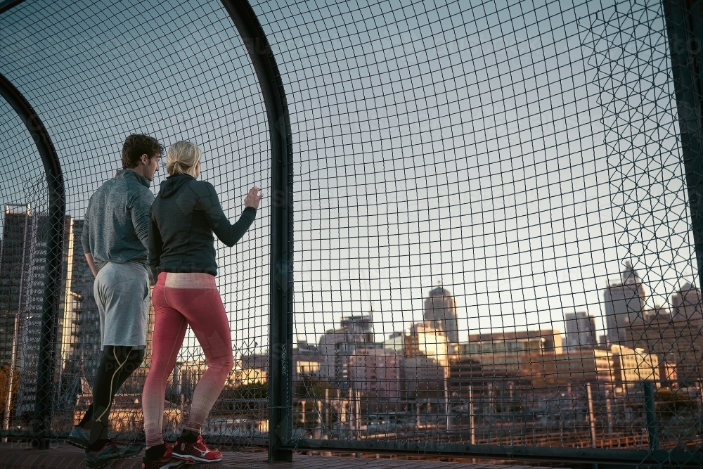 Man and woman resting looking at the cityscape - Australian Stock Image