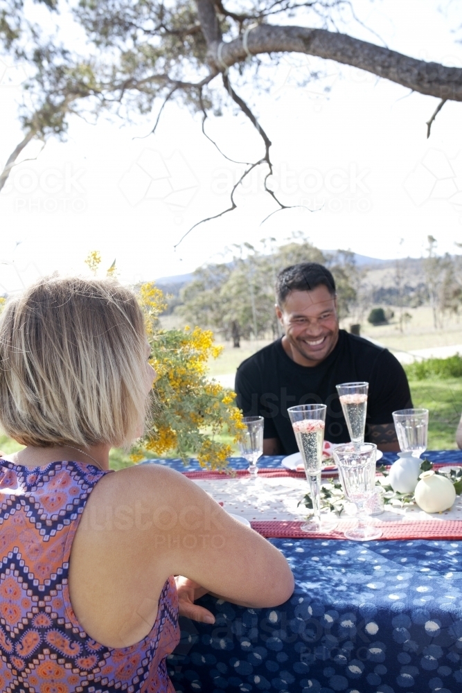 Man and woman sitting at a table outside on Christmas day - Australian Stock Image