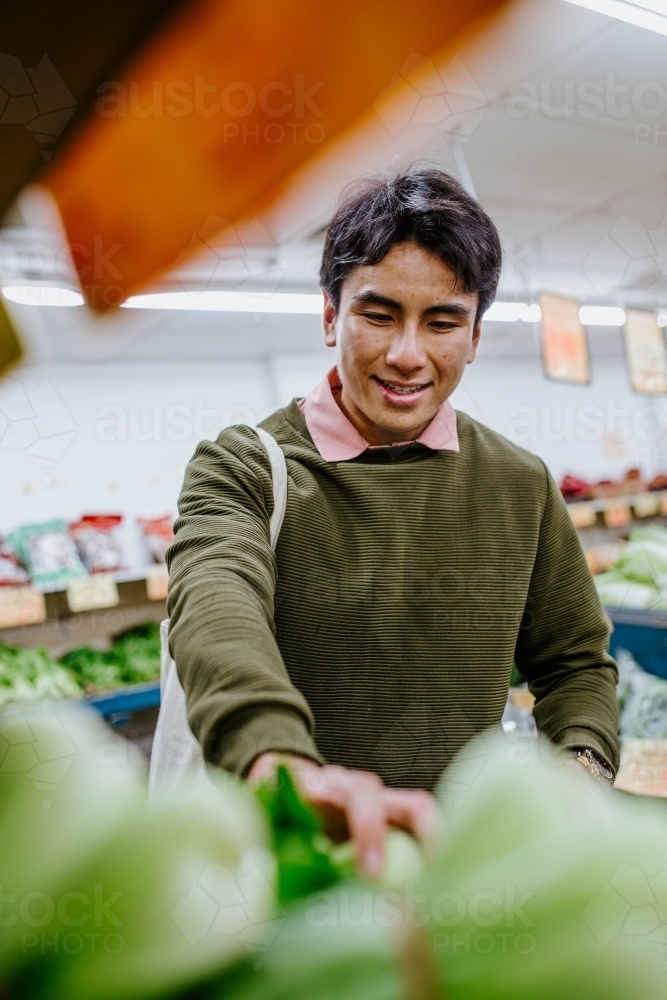 Image of Man buying fresh produce at supermarket Austockphoto