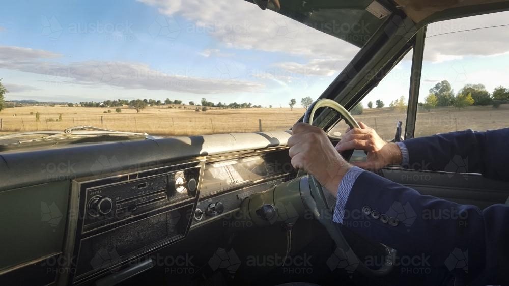 Man driving a classic car (1968 Holden kingswood HK) in the country - Australian Stock Image