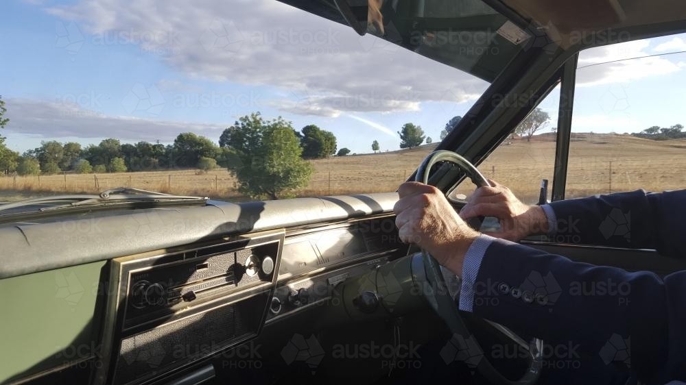 Man driving a classic car in the country - Australian Stock Image