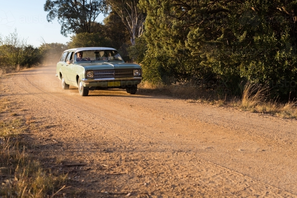 man driving a vintage car in rural Australia - Australian Stock Image