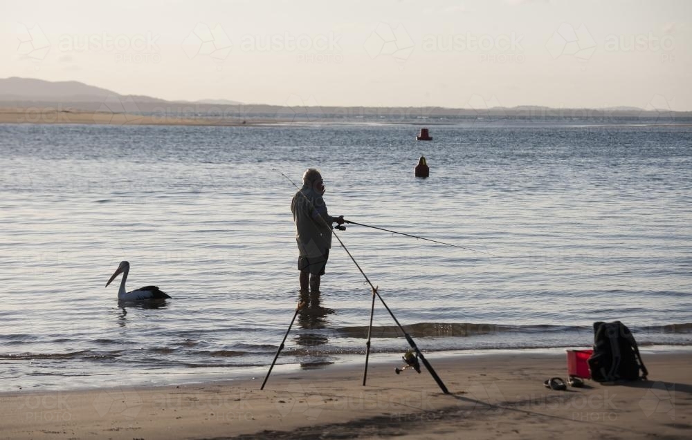 Man fishing at water's edge - Australian Stock Image