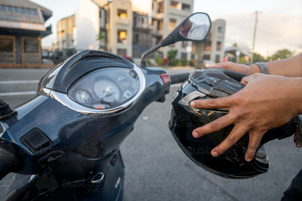 Man getting ready to drive his motorbike, close-up - Australian Stock Image