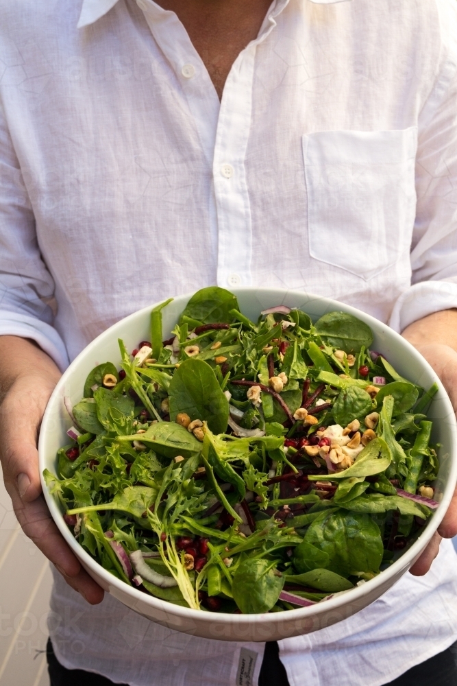 Man holding a bowl of salad - Australian Stock Image