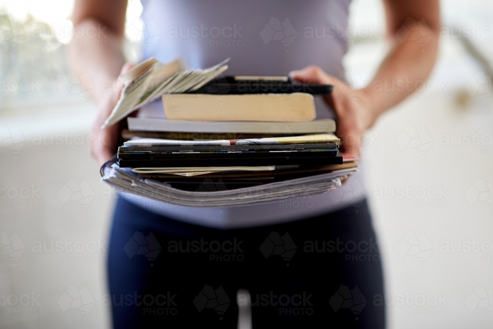 Man holding a pile of business paper-work with both hands - Australian Stock Image