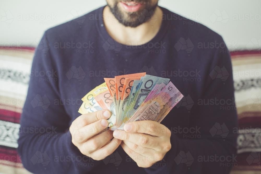 Man holding a selection Australian currency notes - Australian Stock Image