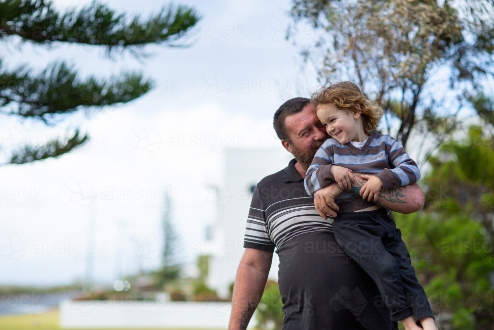 man holding up young child - Australian Stock Image