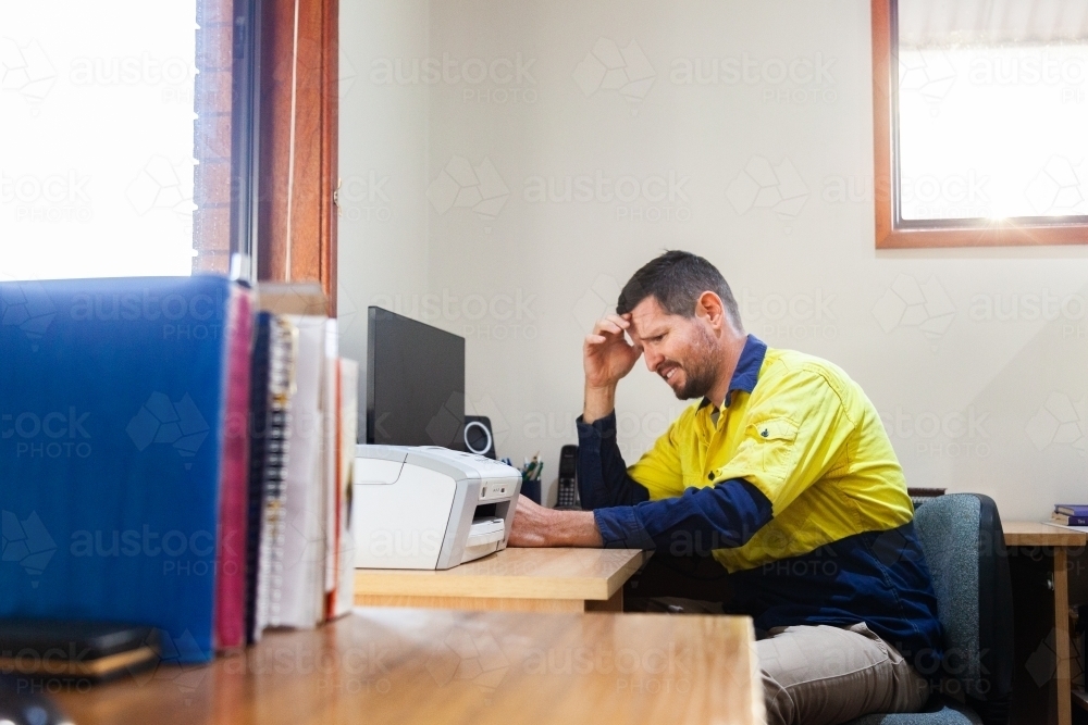 Man in home office feeling unsure - Australian Stock Image