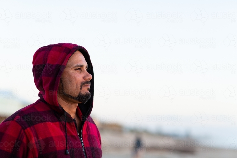man in profile wearing red checked hoody - Australian Stock Image