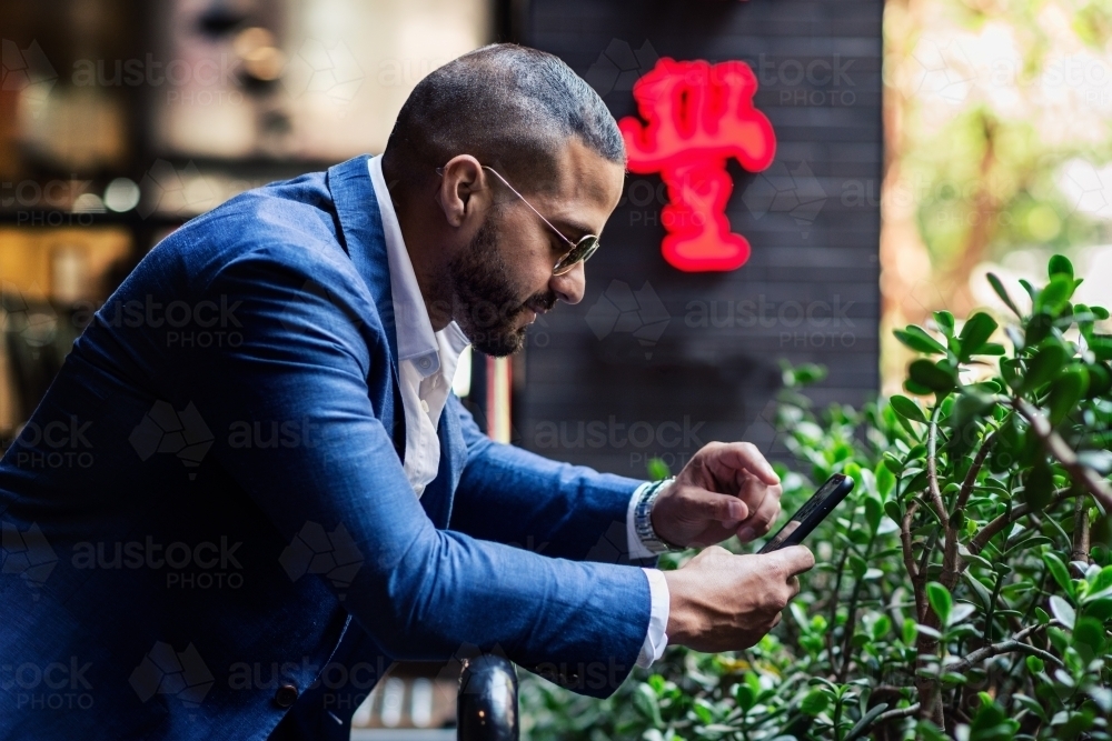 man in the city with phone - Australian Stock Image