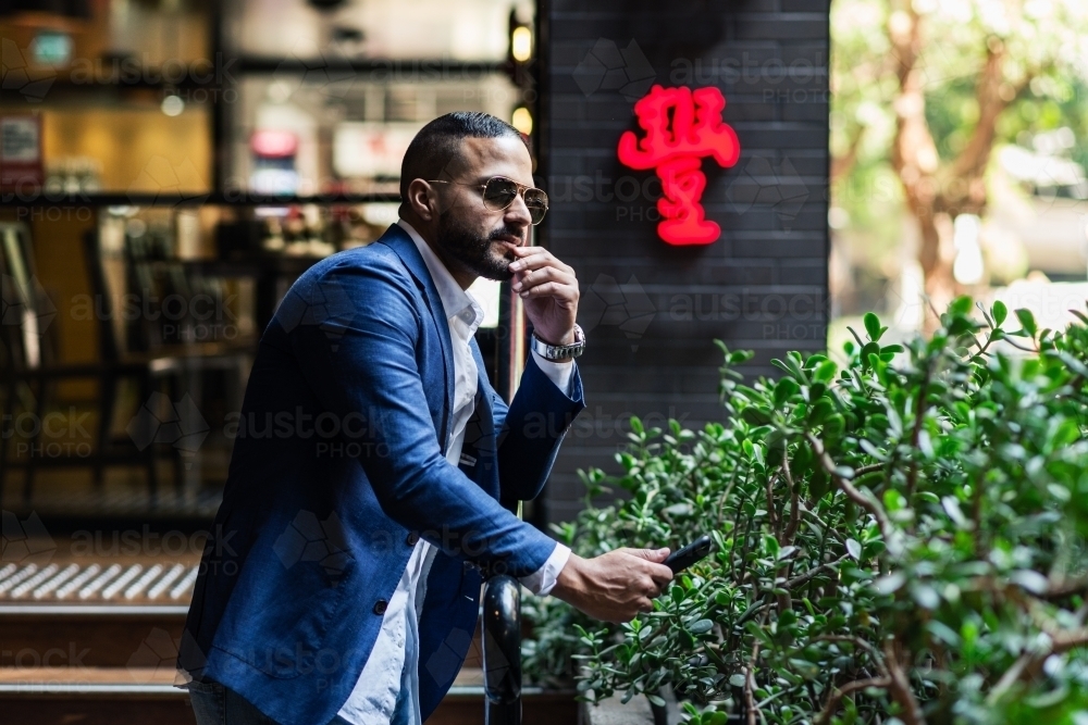 man in the city with phone - Australian Stock Image