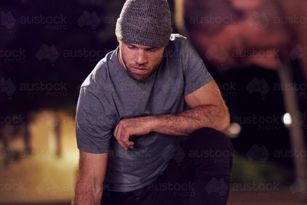 Man in urban city area at night - Australian Stock Image