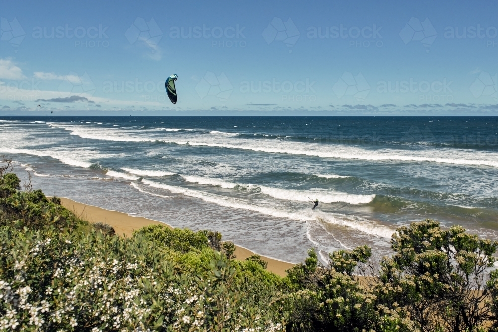 Man kitesurfing at a surf beach - Australian Stock Image