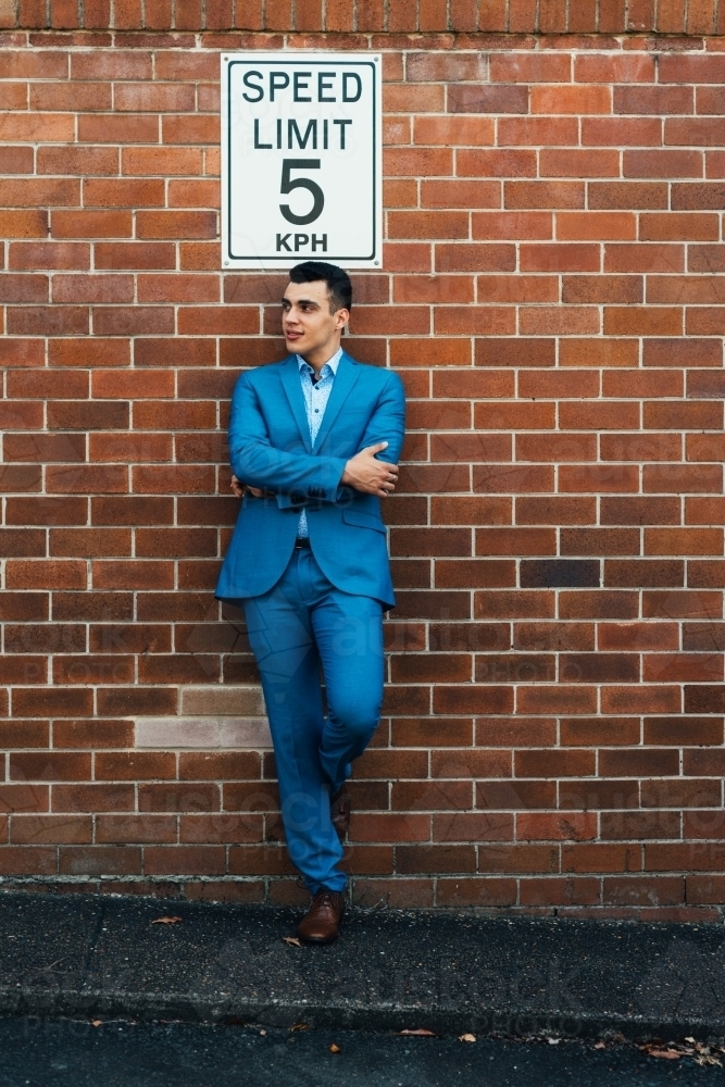 man leaning against wall - Australian Stock Image