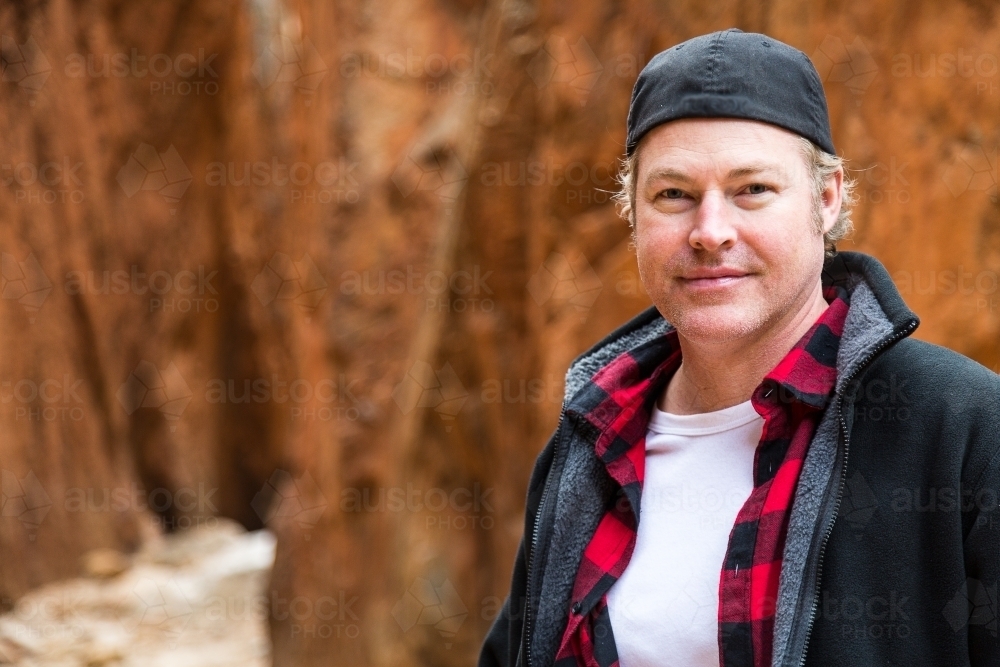 Man looking at camera in standley chasm - Australian Stock Image