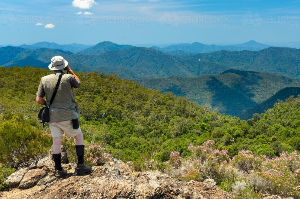 Man looking out at mountains - Australian Stock Image